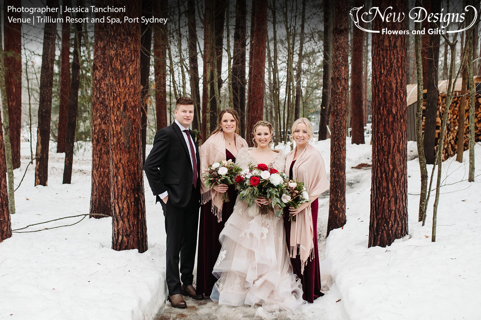 A bride, 2 Bridesmaids and The Man of Honor, stand against a forest in the winter, with bouquets of Wintergreens, Vibrant red roses, Pinecones, and White lisianthus flowers.